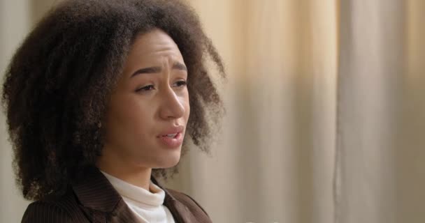 Side view afro american ethnic girl with curly hair complains about problems feels stress pressure holding head from frustration emotionally sharing experience, depression concept close-up female face — Stock Video