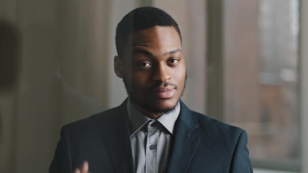 Portrait of young adult african american business man black ethnic entrepreneur posting in office looking at camera showing ok gesture okay sign of confired symbol of well done job and success — Stok Video