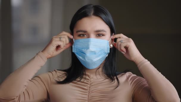 Portrait of charismatic plump model plus size caucasian mexican brazilian girl millennial woman takes off medical mask from her face sincerely smiles rejoices recovery from virus or end of pandemic — Stock Video