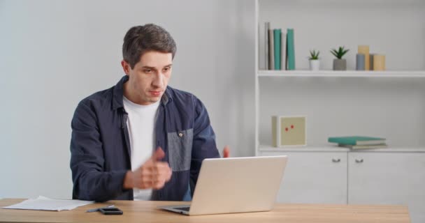 Caucasian man millennial user sitting at table looking at laptop computer screen feeling angry rage, screaming in irritation worried about error in online service or bad news, receives rejected email — Stock Video