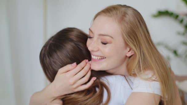 Happy smiling loving adult Caucasian mother woman mom mommy hugs cuddles embraces adored beloved daughter teenage school girl enjoying love indoor, family bonding hugging cuddling embracing at home — Stock Video
