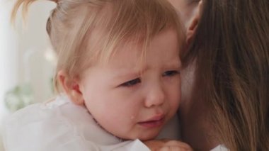 Yakından üzgün küçük bir kız çocuğu. Bebek ağlıyor. Üzüntüden ağlıyor. Acı çekiyor.