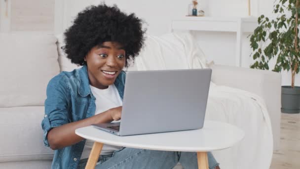 Happy overjoyed African woman read great news feel good surprise about job opportunity. Student girl get online test result scholarship on computer feel winner using look at laptop celebrate success — Stock Video