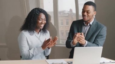 Happy young African students interns talking by video conference call, compliment applauding, celebrating successful completion of collaborative work, international project congratulates colleagues
