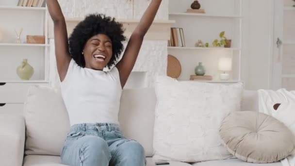 Excited overjoyed young African American woman customer hold smartphone read good news in SMS message, feel great surprise bid win game app, celebrate success screaming yes, mobile victory concept — Vídeo de stock