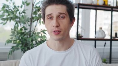 Webcam view male head face caucasian millennial man adult guy blogger vlogger influencer speaking explaining talking remote conversation looking at camera record vlog video online chat conference call