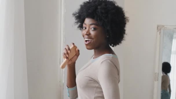 Jovem atraente afro-americano milenar mulher dançando cantando música favorita ouvir música na playlist digital desfrutar despreocupado fim de semana em casa sozinho. Hobby, tecnologia moderna, conceito de estilo de vida livre de estresse — Vídeo de Stock