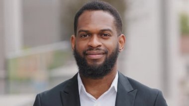 Yakın plan iş portresi, gülümseyen Afro-Amerikan erkek profesyonel yönetici dışarıda kameraya bakıyor, mutlu, kendine güvenen, siyahi, iş adamı, patron ya da stajyer.