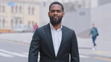 Serious strong decisive African bearded young adult ethnic male puts palm in front of him, confidently shows stop gesture, against violence, demonstrate NO sign, distance, defends personal boundaries