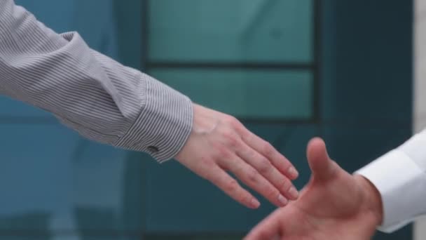 Close up part of human body caucasian woman and man shake hands, conclude successful contract deal agreement, support partnership sign cooperation, businessman and businesswoman greet gesture outdoors — Stock Video