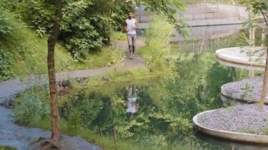 Yakışıklı atletik Afrikalı genç adam, koşuyor, dışarıda çalışıyor, sabah koşusunda, güneşli yaz aylarında parkta günlük antrenman yapıyor. Her gün spor, milenyum fitness, aktif sağlıklı yaşam tarzı konsepti