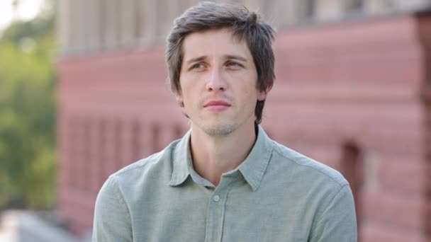 Headshot closeup portrait unhappy young Caucasian guy sniffing air closing nose holding breath. Millennial man suffering from unpleasant stinky intolerable disgusting smell avoiding nasty strong odor — Stock Video