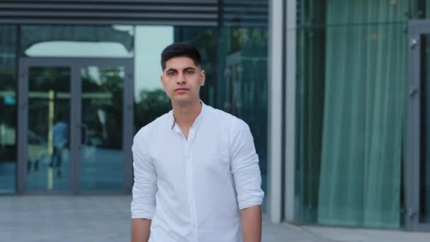 Close-up headshot confident serious concentrated Indian Arabic young man wearing shirt stand posing with arms crossed, looking at camera portrait. Thoughtful millennial guy student or businessman — Stock Video