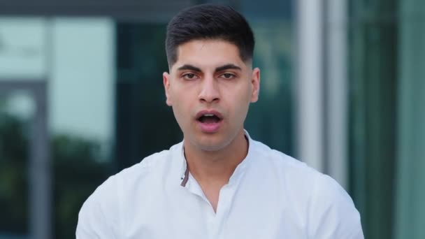 Stop it. Angry furious young businessman in white shirt stressed about high taxes or delivery delays, mad manager showing aggression negative attitude, racial discrimination unfair treatment concept — Stock Video