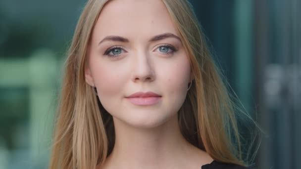 Portrait of smiling confident white-skinned European Caucasian millennial woman on blue background, beautiful happy young blonde female model with healthy skin look at camera posing shooting casting — Stock Video