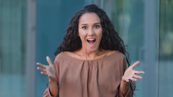 Female portrait outdoors happy facial expression. Hispanic lucky successful shocked woman winner feeling shock delight surprise open mouth surprised rejoice winning victory holding head from good news — Stock Video