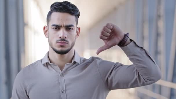 Close up male portrait hispanic bearded man arabic handsome serious businessman guy advisor unsatisfied client looking at camera showing thumb down gesture negative attitude disapproval bad assessment — Stock Video