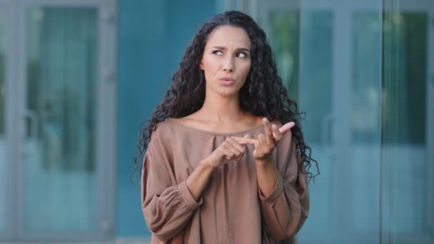 Close up smiling friendly happy hispanic young mixed race woman girl female standing outdoors city building background counting number accounting using hands counts fingers looking at camera countdown — Vídeo de stock