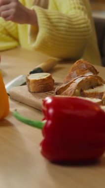 Mutfaktaki mutlu beyaz aile 10 'lu yaşlarda, küçük beyaz kız çocuğu vejetaryen, sağlıklı yemek pişiriyor, salata yapıyor sebzeleri karıştırıyor, baba destek oluyor, sarılıyor, kızı kucaklıyor.