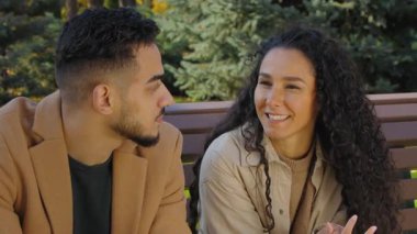 Sonbahar parkında pozitif Arap bir çift olarak konuşuyoruz. İlişki buluşmasının tadını çıkarıyoruz. Kadın erkeğe konuşuyoruz.