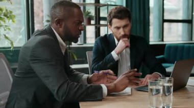 İki farklı insan çok ırklı iş adamları online proje çözme problemini tartışıyorlar. İnternet görevi, beyaz Afrikalı Afrikalı Afro-Amerikalı iş adamları ortaklığında dizüstü bilgisayarla ilgili bir sorun.