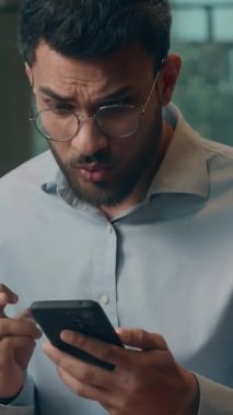 Hintli iş adamı Arap işadamı cep telefonuyla bekliyor. Kafede cep telefonundan memnun olmayan, memnun olmayan bir erkek çocuğu kaybetmeyi umuyor. Haberler kötü olsun.