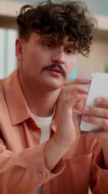 Frustrated Caucasian businessman with mobile phone feeling sad business man holding smartphone failure online problem internet connection lost trouble receive sms message bad news male guy in office