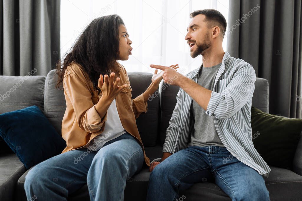 Married young couple emotional discuss about something, they having problem. African american woman and caucasian man disagree with each other have a misunderstanding, cant make decision, a quarrel