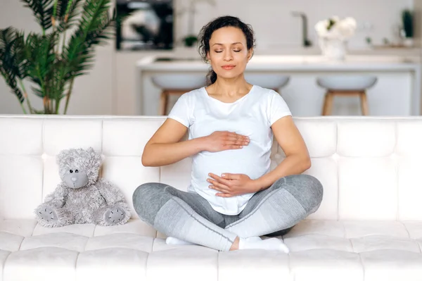 woman mixed race meditation lotus position pregnant