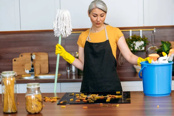 asian housewife, lady, apron, gloves, mop, mess, stove