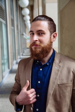 Bearded hipster wearing shirt in the city