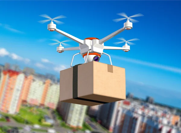 Quadrocopter with cardboard package — Stock Photo, Image
