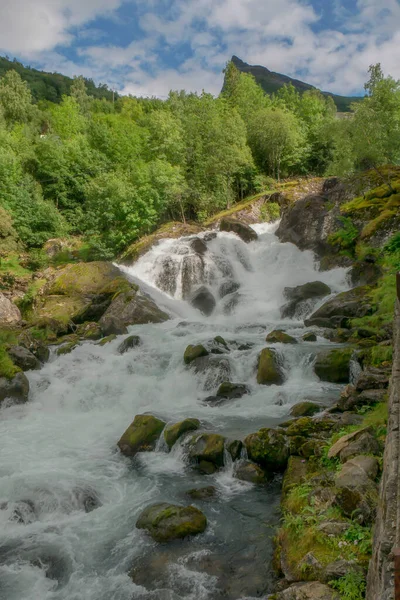 River Storfossen runs down the mountain to the Geiranger Fjord, Norway. Nature landscape, river.