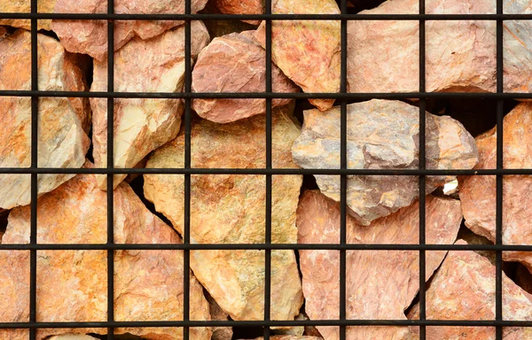 A volcanic stone and steel net fence texture — Stock Photo, Image