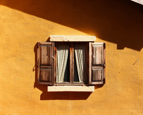 Vintage window on yellow cement wall — Stock Photo, Image