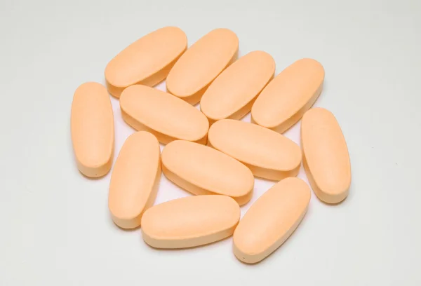 A fehér narancssárga tabletta — Stock Fotó
