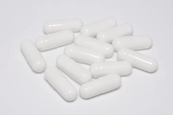 White capsule pills on white — Stock Photo, Image