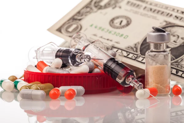 Pile of medicines, one dollar and syringes — Stock Photo, Image