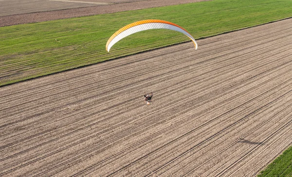 Парамотор, летающий над полями — стоковое фото
