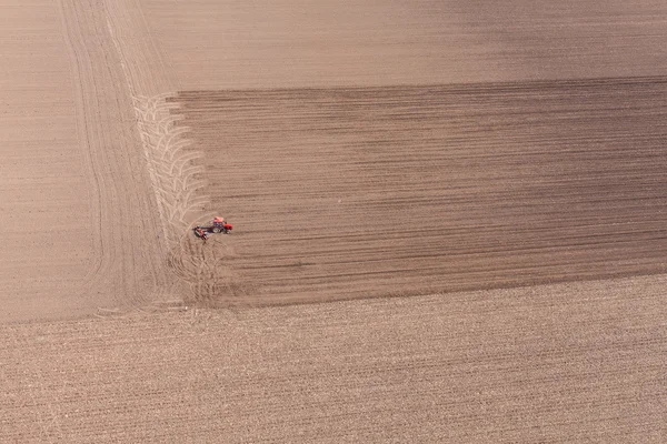 Tractor on harvest field — Stock Photo, Image