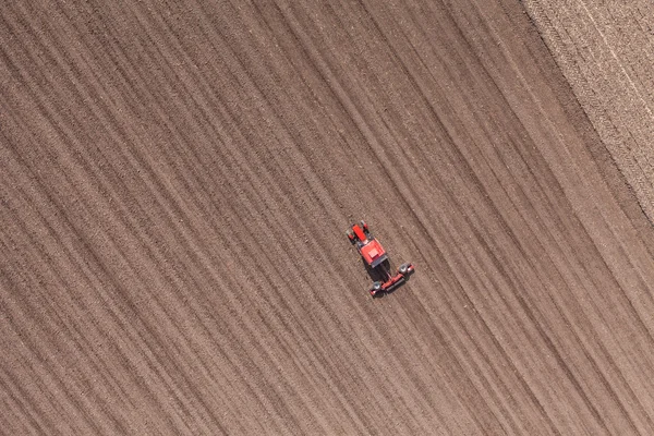 Tractor on harvest field — Stock Photo, Image