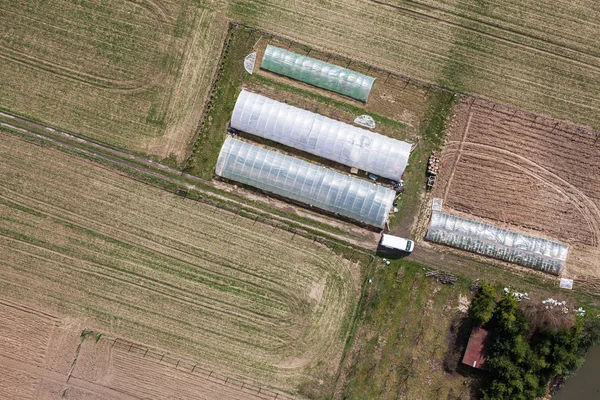Greenhouses and harvest fields — Stock Photo, Image