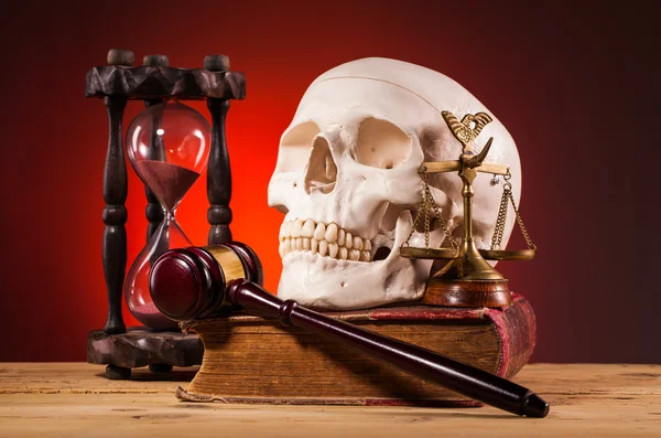 Human scull, gavel, scales of justice and old book — Stock Photo, Image
