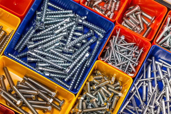 Screws located in a colorful box — Stock Photo, Image