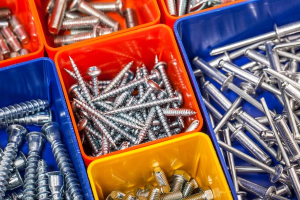 Screws located in a colorful box — Stock Photo, Image