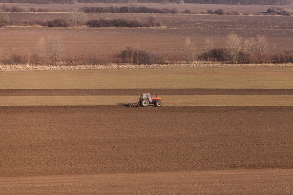 Harvest fields with tractor — Stock Photo, Image