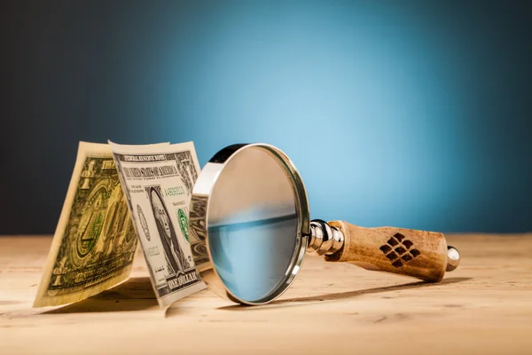 Dollar money and magnifying glass — Stock Photo, Image