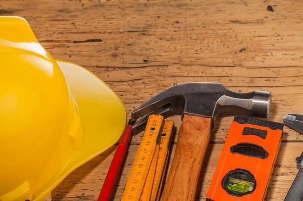 Yellow helmet and wood mounting tools — Stock Photo, Image