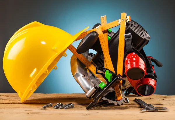 Capacete amarelo e ferramentas de montagem de madeira — Fotografia de Stock