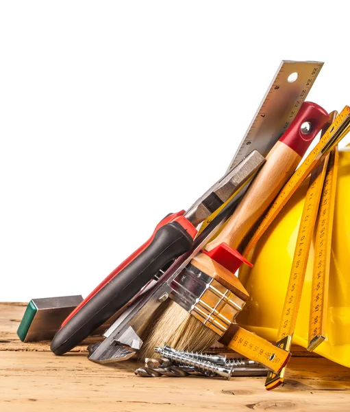 Yellow helmet and wooden mounting tools — Stock Photo, Image